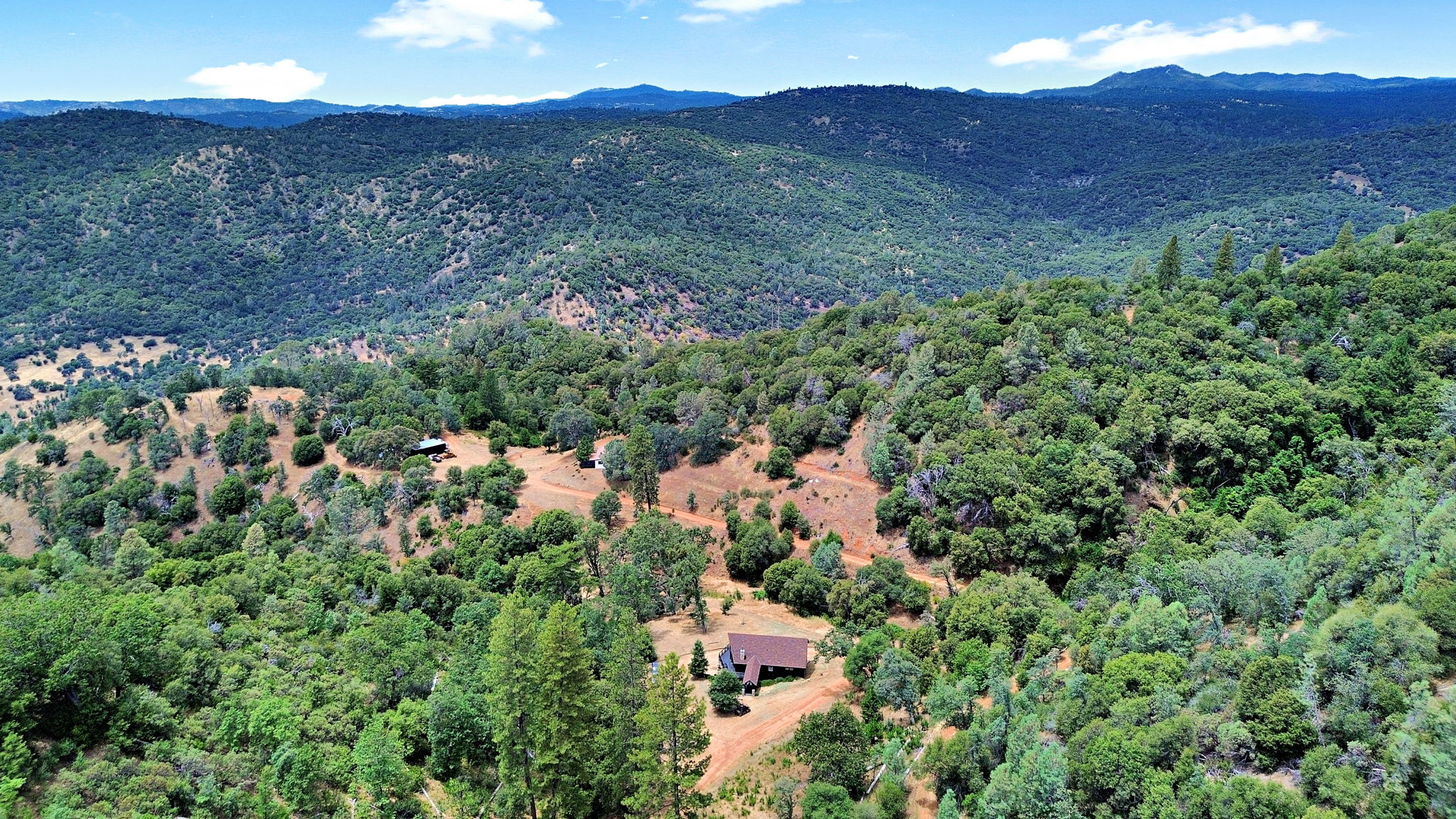 Drone view of forested ridges and meadows